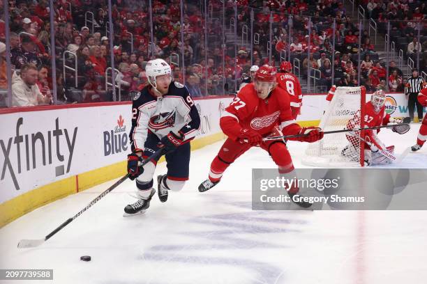 Alexander Nylander of the Columbus Blue Jackets looks to pas around Simon Edvinsson of the Detroit Red Wings during the first period at Little...