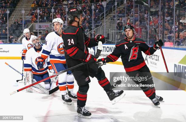 Seth Jarvis of the Carolina Hurricanes celebrates his goal at 12:48 of the first period against the New York Islanders at UBS Arena on March 19, 2024...