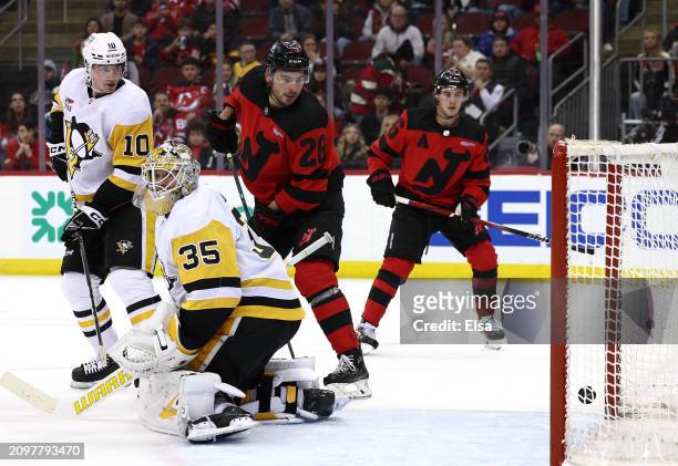 Timo Meier of the New Jersey Devils scores a goal as Tristan Jarry of the Pittsburgh Penguins defends during the second period at Prudential Center...