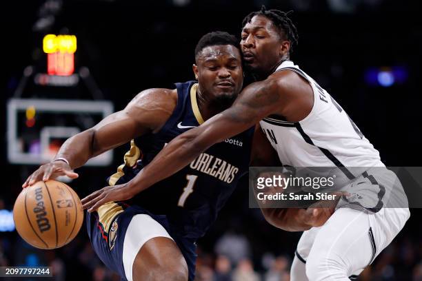 Zion Williamson of the New Orleans Pelicans dribbles against Dorian Finney-Smith of the Brooklyn Nets during the first half at Barclays Center on...