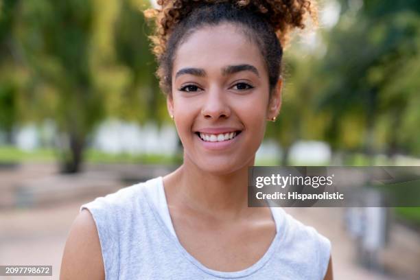 beautiful athletic woman smiling outdoors - hispanolistic stockfoto's en -beelden