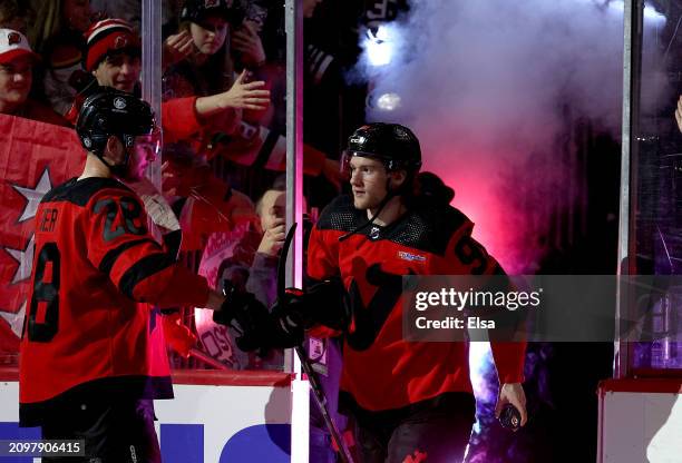 Timo Meier of the New Jersey Devils congratulates teammate Dawson Mercer after he was awarded the second star after the game against the Pittsburgh...