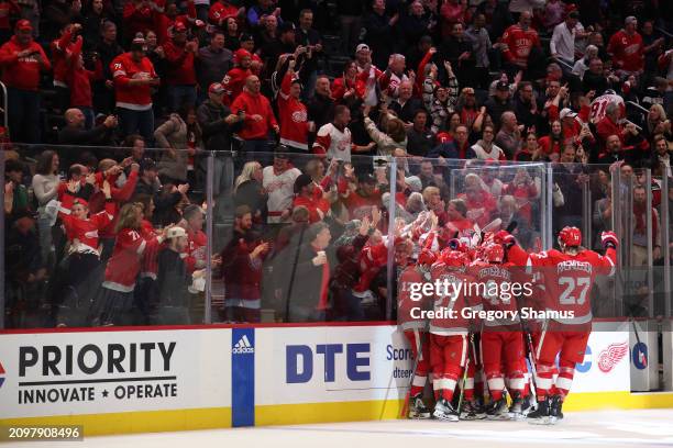 The Detroit Red Wings celebrate their 4-3 overtime win over the Columbus Blue Jackets at Little Caesars Arena on March 19, 2024 in Detroit, Michigan.