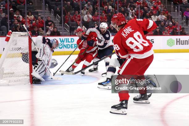 Patrick Kane of the Detroit Red Wings scores past Daniil Tarasov of the Columbus Blue Jackets to win 4-3 in overtime at Little Caesars Arena on March...