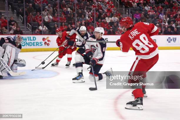 Patrick Kane of the Detroit Red Wings scores past Daniil Tarasov of the Columbus Blue Jackets to win 4-3 in overtime at Little Caesars Arena on March...