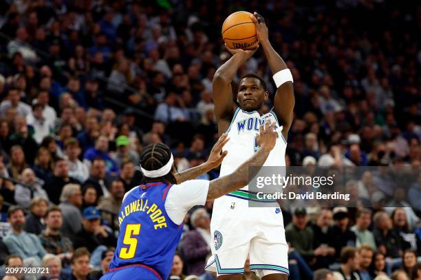 Anthony Edwards of the Minnesota Timberwolves shoots the ball against Kentavious Caldwell-Pope of the Denver Nuggets in the first quarter at Target...