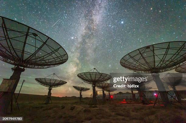 satellite antenna array under the milky way sky - parabola stock pictures, royalty-free photos & images