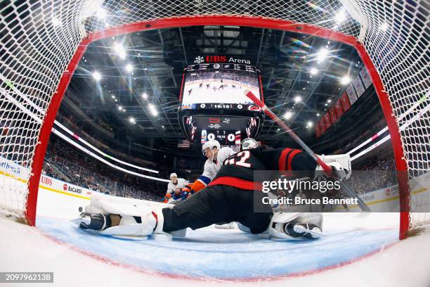 Pyotr Kochetkov of the Carolina Hurricanes defends against Bo Horvat of the New York Islanders during the third period at UBS Arena on March 19, 2024...