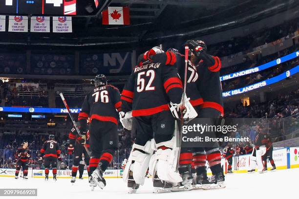 The Carolina Hurricanes celebrate a 4-1 victory over the New York Islanders at UBS Arena on March 19, 2024 in Elmont, New York.