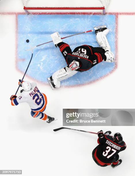 Kyle Palmieri of the New York Islanders scores a third period goal against Pyotr Kochetkov of the Carolina Hurricanes at UBS Arena on March 19, 2024...