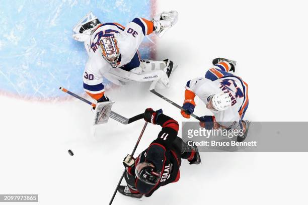 Ilya Sorokin of the New York Islanders defends against Jordan Staal of the Carolina Hurricanes during the second period at UBS Arena on March 19,...