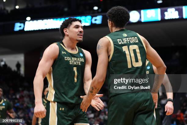 Joel Scott and Nique Clifford of the Colorado State Rams celebrate after a basket and foul during the second half against the Virginia Cavaliers in...