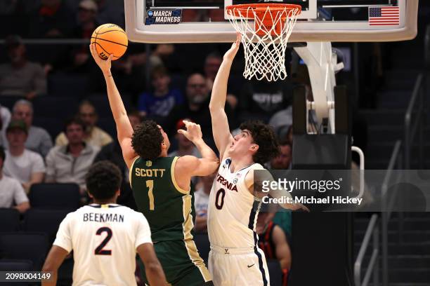 Joel Scott of the Colorado State Rams shoots against Blake Buchanan of the Virginia Cavaliers during the second half in the First Four game during...