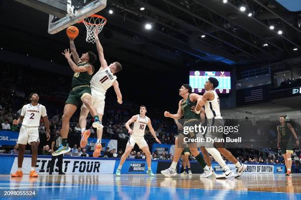 Nique Clifford of the Colorado State Rams battles against Isaac McKneely of the Virginia Cavaliers during the second half in the First Four game...