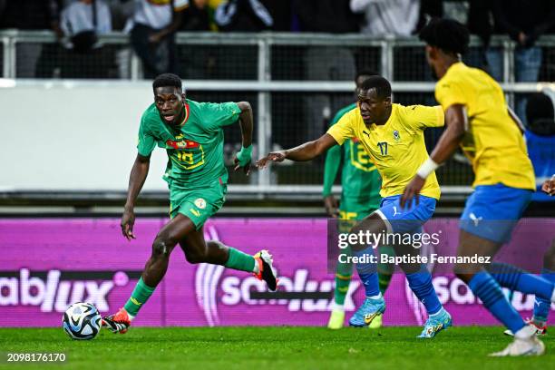 Ismaila SARR of Senegal and Michel MBOULA of Gabon during the International friendly match between Senegal and Gabon at Stade de la Licorne on March...
