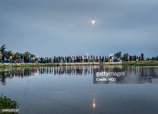 People gather and watch the launch of relay satellite Queqiao-2 at the Wenchang Spacecraft Launch Site on March 20, 2024 in Wenchang, Hainan Province...