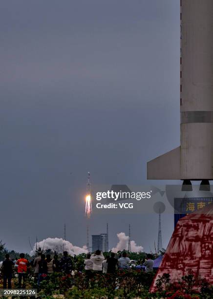 People gather and watch the launch of relay satellite Queqiao-2 at the Wenchang Spacecraft Launch Site on March 20, 2024 in Wenchang, Hainan Province...