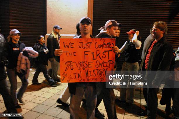 Boston Red Sox fans celebrate outside of Yankee Stadium after the Boston Red Sox win the 7th game of the American League playoffs by the score of 10...