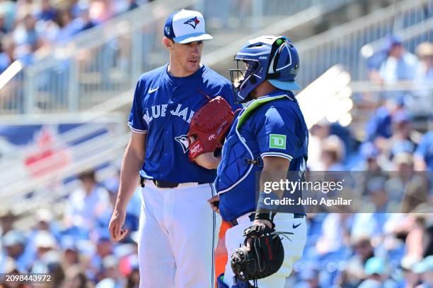 Alejandro Kirk visits with Chris Bassitt of the Toronto Blue Jays on the mound in the third inning against the Baltimore Orioles during a 2024...