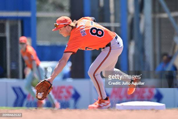 Jackson Holliday of the Baltimore Orioles grabs a ground ball in the third inning against the Toronto Blue Jays during a 2024 Grapefruit League...