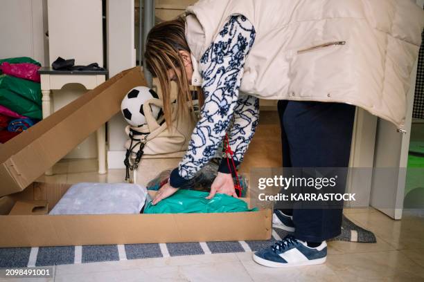 woman preparing packages of clothes and shoes at home to sell them on an online app. - collection backstage stock pictures, royalty-free photos & images