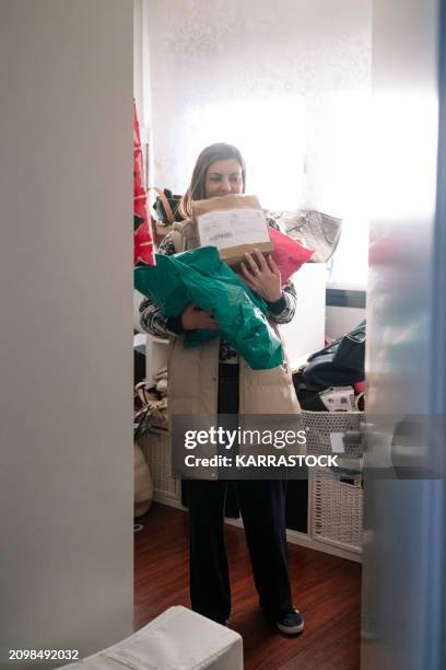 woman preparing packages of clothes and shoes at home to sell them on an online app. - collection backstage stock pictures, royalty-free photos & images