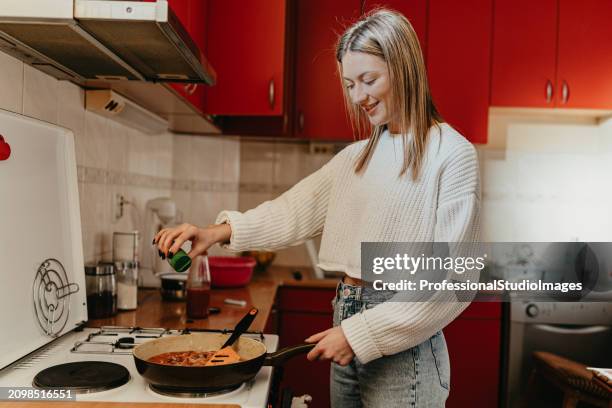 the alchemy of cooking at home - hot housewives stock pictures, royalty-free photos & images