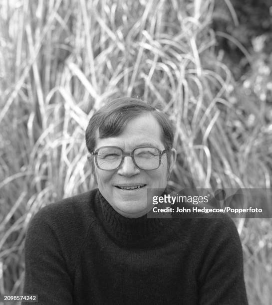 English writer and novelist Colin Wilson posed in the garden of his house in Cornwall, England in 1987.