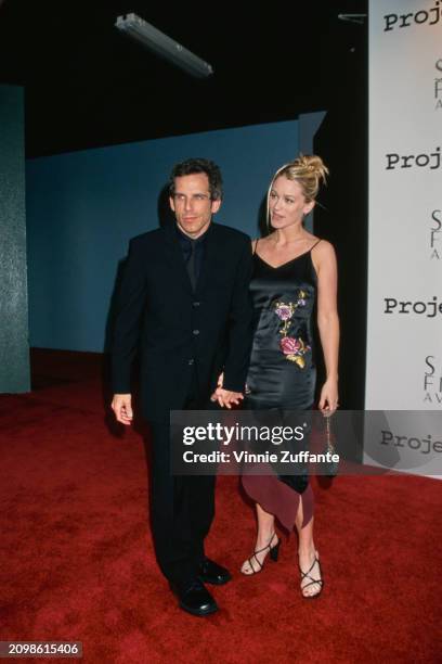 American actor and comedian Ben Stiller, wearing a black suit with a black shirt and a black tie, and his fiancee, American actress Christine Taylor,...