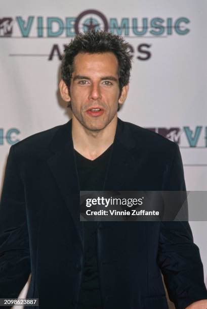 American actor and comedian Ben Stiller, wearing a black suit over a black v-neck sweater, in the press room of the 1998 MTV Video Music Awards, held...