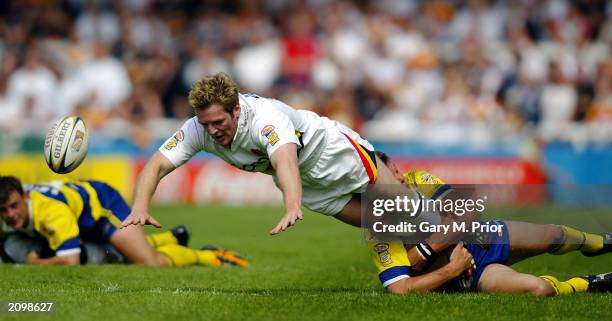 Karl Pratt of Bradford Bulls loses the ball as he is tackled during the Tetleys Super League match between Warrington Wolves and Bradford Bulls held...