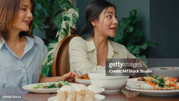 young asian family preparing chinese food and having fun sitting at dining table at backyard outside home. multi-generation family enjoying spending together. - chinese eating backyard stock pictures, royalty-free photos & images