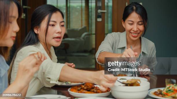 young asian family preparing chinese food and having fun sitting at dining table at backyard outside home. multi-generation family enjoying spending together. - chinese eating backyard stock pictures, royalty-free photos & images
