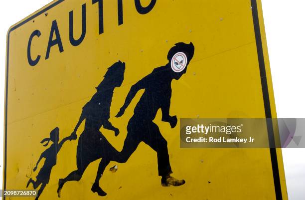 Close-up of a 'Caution' pedestrian crossing sign on Highway 905 , San Diego, California, August 1, 2002. The sign was placed in a high pedestrian...