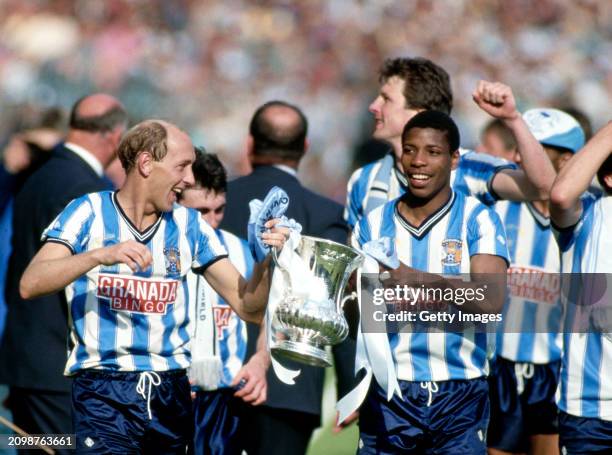 Coventry City players Greg Downs and Lloyd McGrath pictured with the trophy after the 1987 FA Cup Final between Coventry City and Tottenham Hotspur...