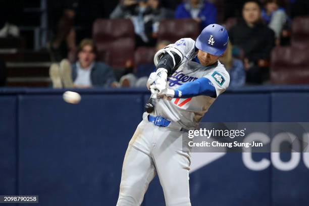 Shohei Ohtani of the Los Angeles Dodgers hits a single in the 3rd inning during the 2024 Seoul Series game between Los Angeles Dodgers and San Diego...