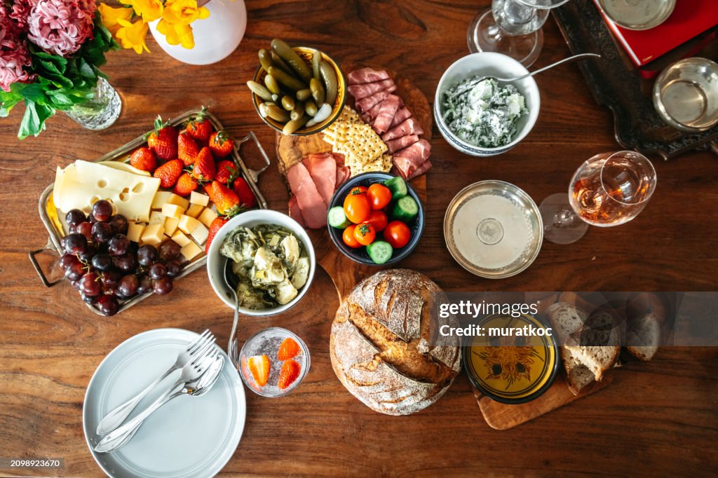 Rich brunch table with selection of delicious food and drinks