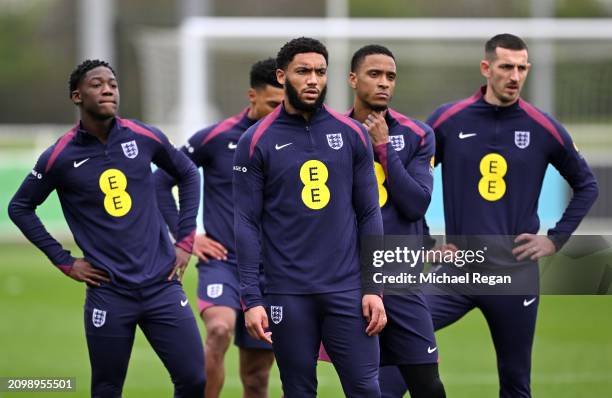 Kobbie Mainoo, Joe Gomez, Ezri Konsa and Lewis Dunk of England look on during a training session at St Georges Park on March 20, 2024 in...