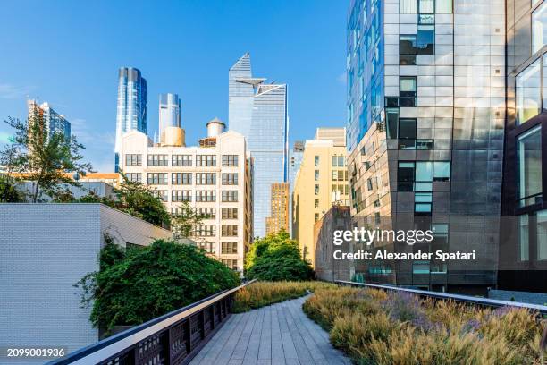 high line park and 'hudson yards' skyscrapers in chelsea district, new york city, usa - luxury new york apartment stock pictures, royalty-free photos & images