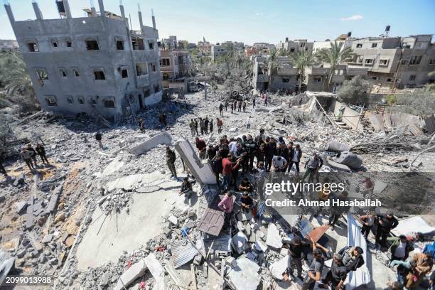 People inspect damage and recover items from their homes following Israeli air strikes on March 20, 2024 in Rafah, Gaza. Despite warnings from US...