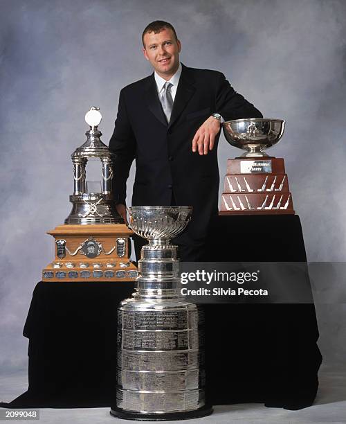 Martin Brodeur of the New Jersey Devils poses with the Vezina Trophy , William M. Jennings Trophy and the Stanley Cup during the 2002-03 NHL Awards...