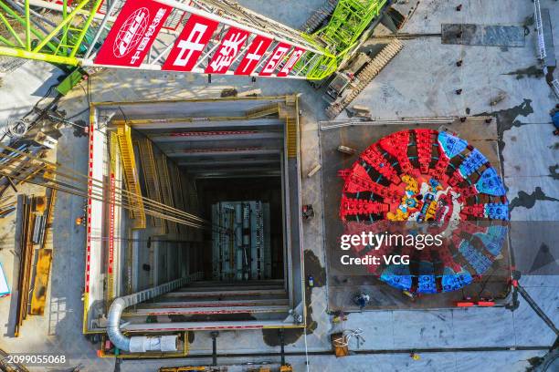 Aerial view of workers assembling 'Yongzhou' tunnel boring machine on March 20, 2024 in Ningbo, Zhejiang Province of China. The shield tunneling...