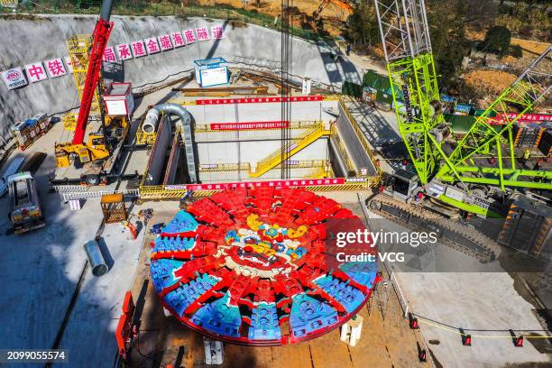 Aerial view of workers assembling 'Yongzhou' tunnel boring machine on March 20, 2024 in Ningbo, Zhejiang Province of China. The shield tunneling...