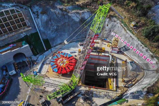 Aerial view of workers assembling 'Yongzhou' tunnel boring machine on March 20, 2024 in Ningbo, Zhejiang Province of China. The shield tunneling...