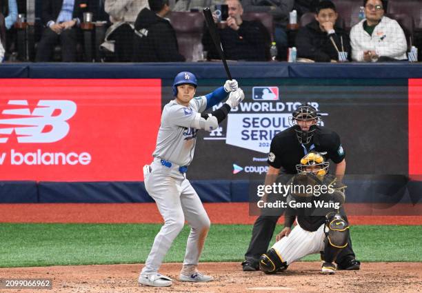 Shohei Ohtani of Los Angeles Dodgers hits a 2RBI single in the top of the eighth inning during the 2024 Seoul Series game between Los Angeles Dodgers...