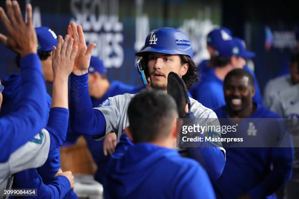 James Outman of the Los Angeles Dodgers celebrates with teammates after scoring a run by a RBI single of Mookie Betts in the 8th inning during the...