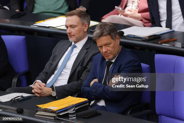 Finance Minister Christian Lindner and Economy and Climate Action Minister Robert Habeck listen as German Chancellor Olaf Scholz gives a declaration...