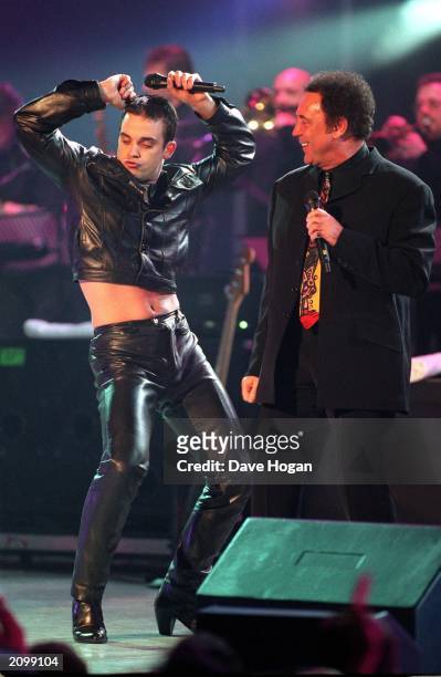 Pop sensation Robbie Williams and veteran singer Tom Jones perform a medley of tracks from hit movie 'The Full Monty' at the Brit Awards on February...