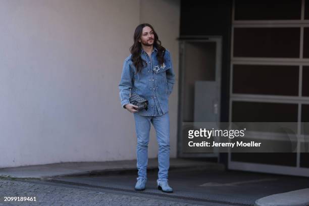 Riccardo Simonetti seen wearing Y Project blue denim jacket with rhinestone pattern star brooches, Levi’s blue denim straight leg pants / jeans,...