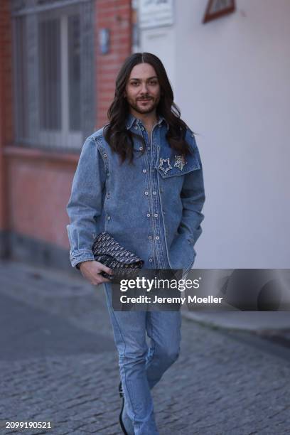 Riccardo Simonetti seen wearing Y Project blue denim jacket with rhinestone pattern star brooches, Levi’s blue denim straight leg pants / jeans,...